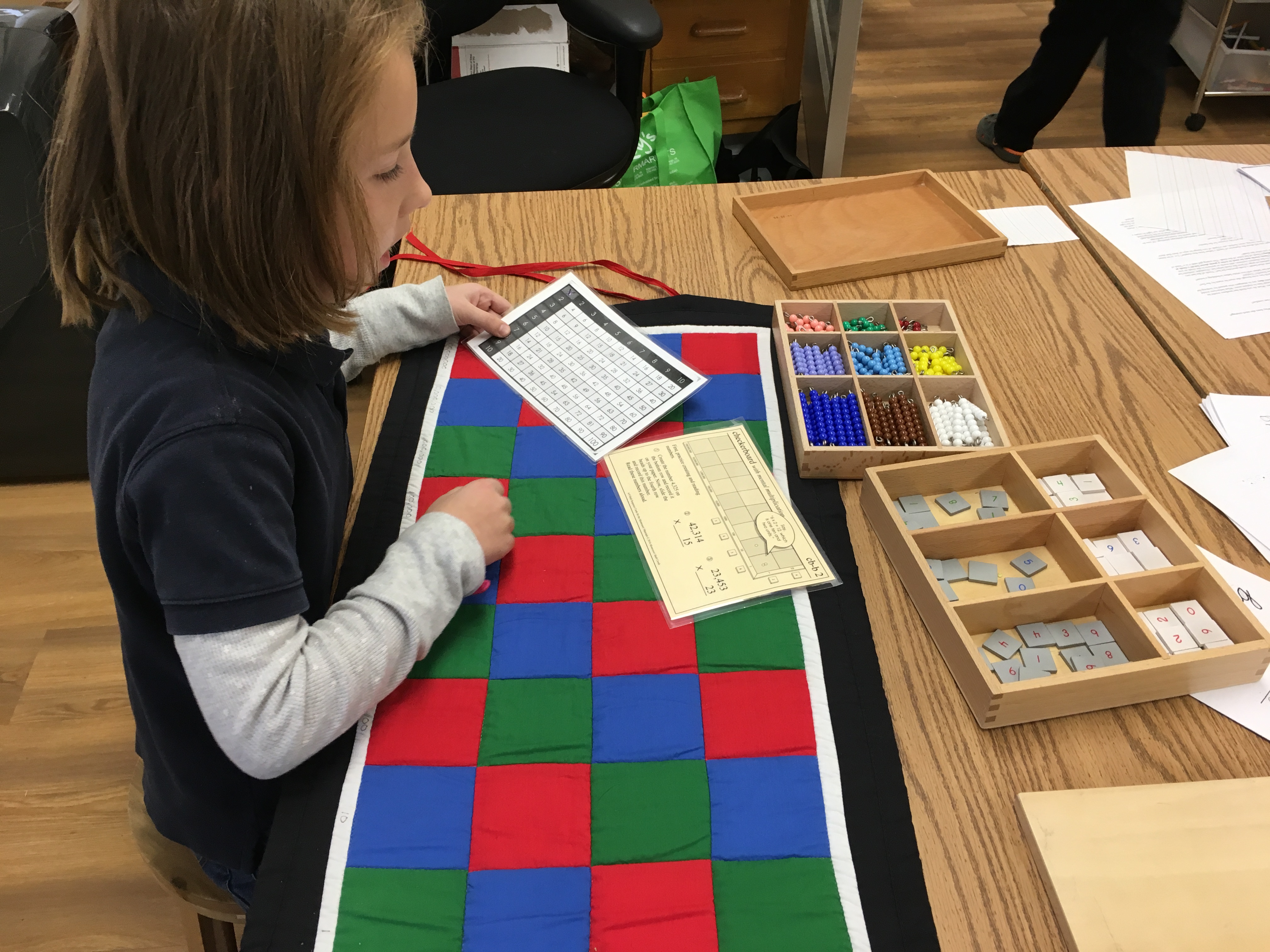 child doing mathematics with a checkerboard