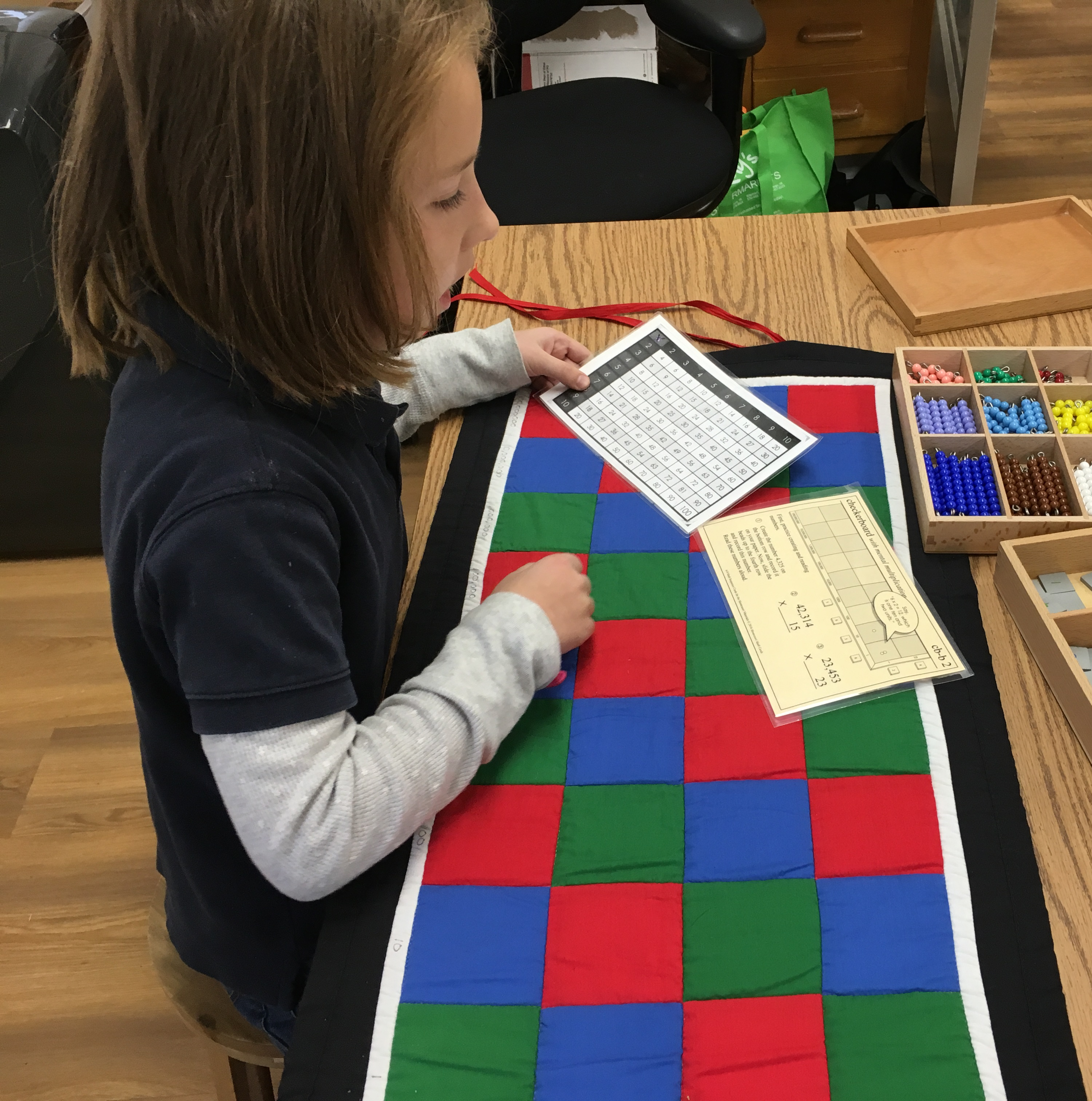 child doing mathematics with a checkerboard