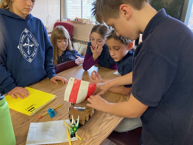 children working on a model boat