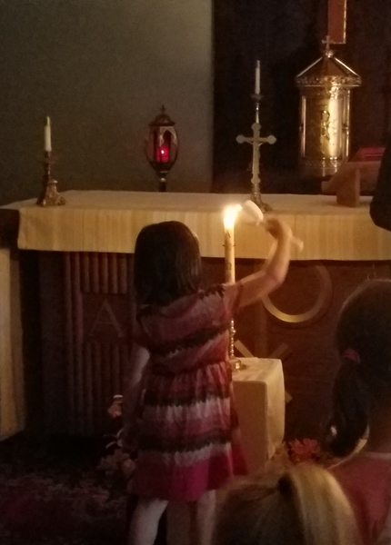 child lighting candle